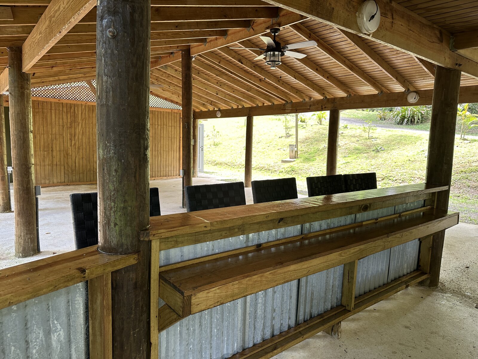 Interior of Batey Zumbador with long bar, woven seating, and ceiling fan