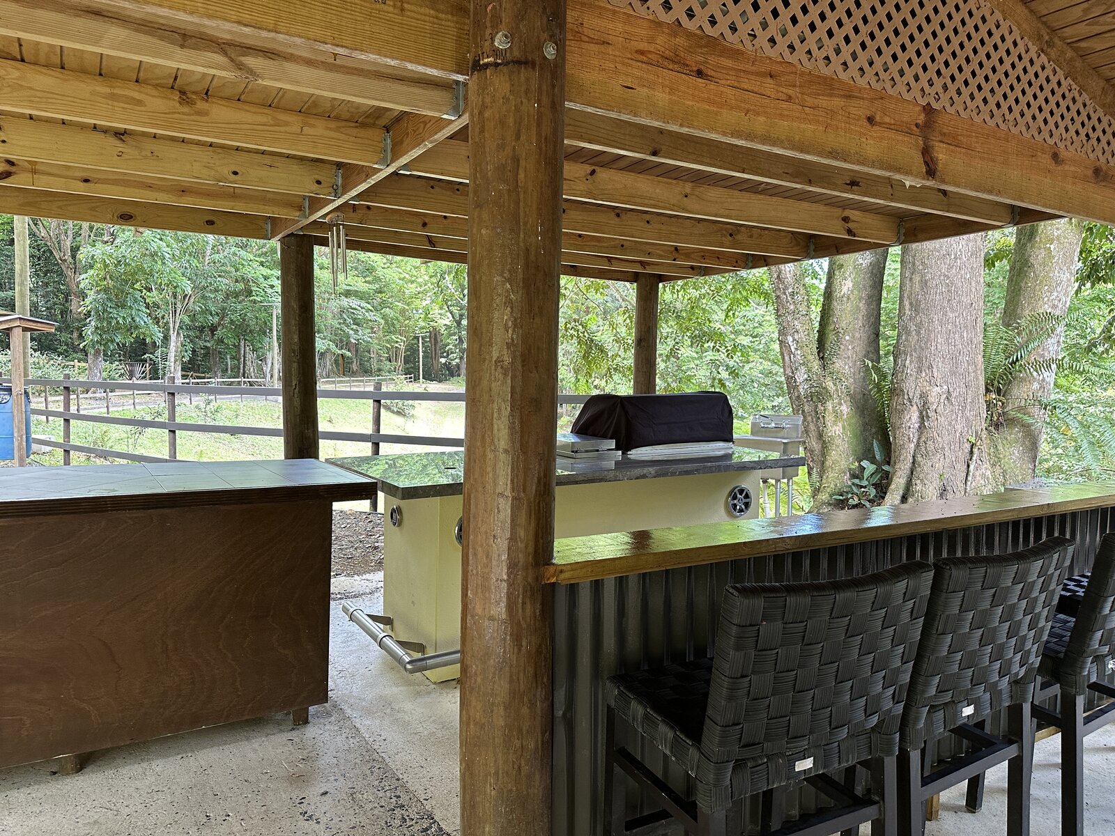 Granite-topped bar and BBQ counter with seating at Batey Zumbador