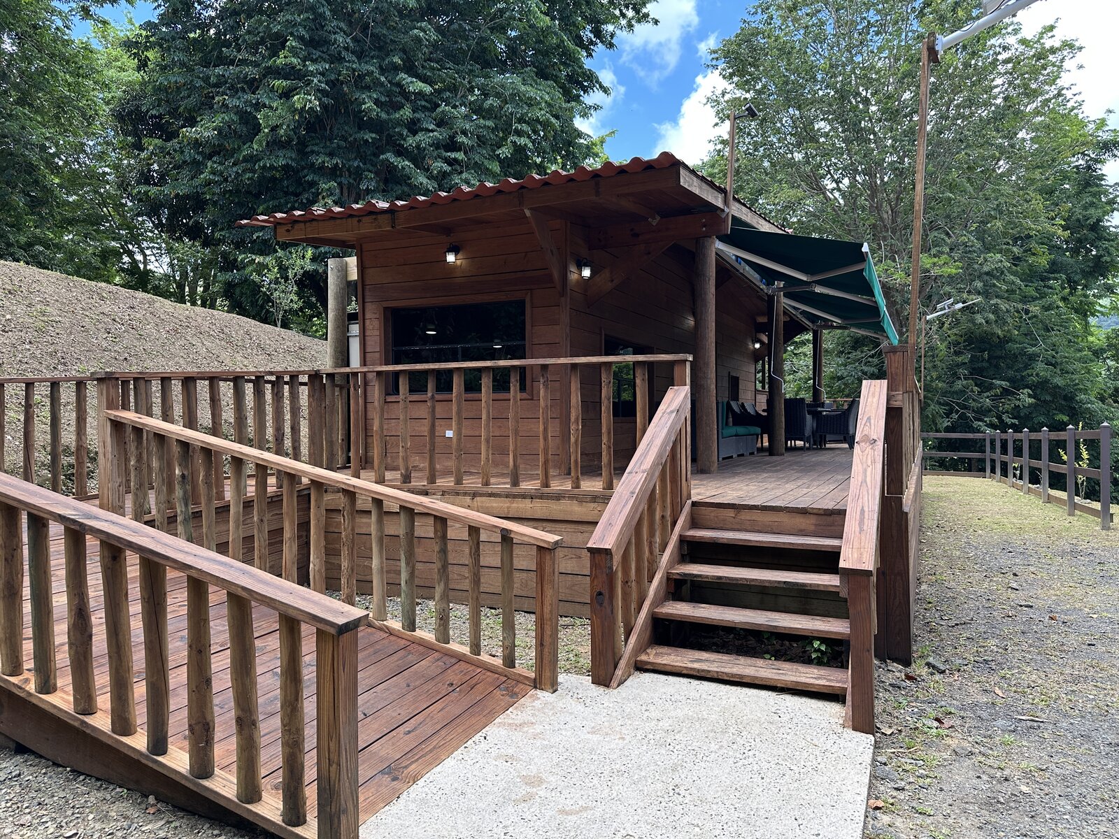 Front entrance of Casa Bambú with accessible ramp, steps, and covered porch