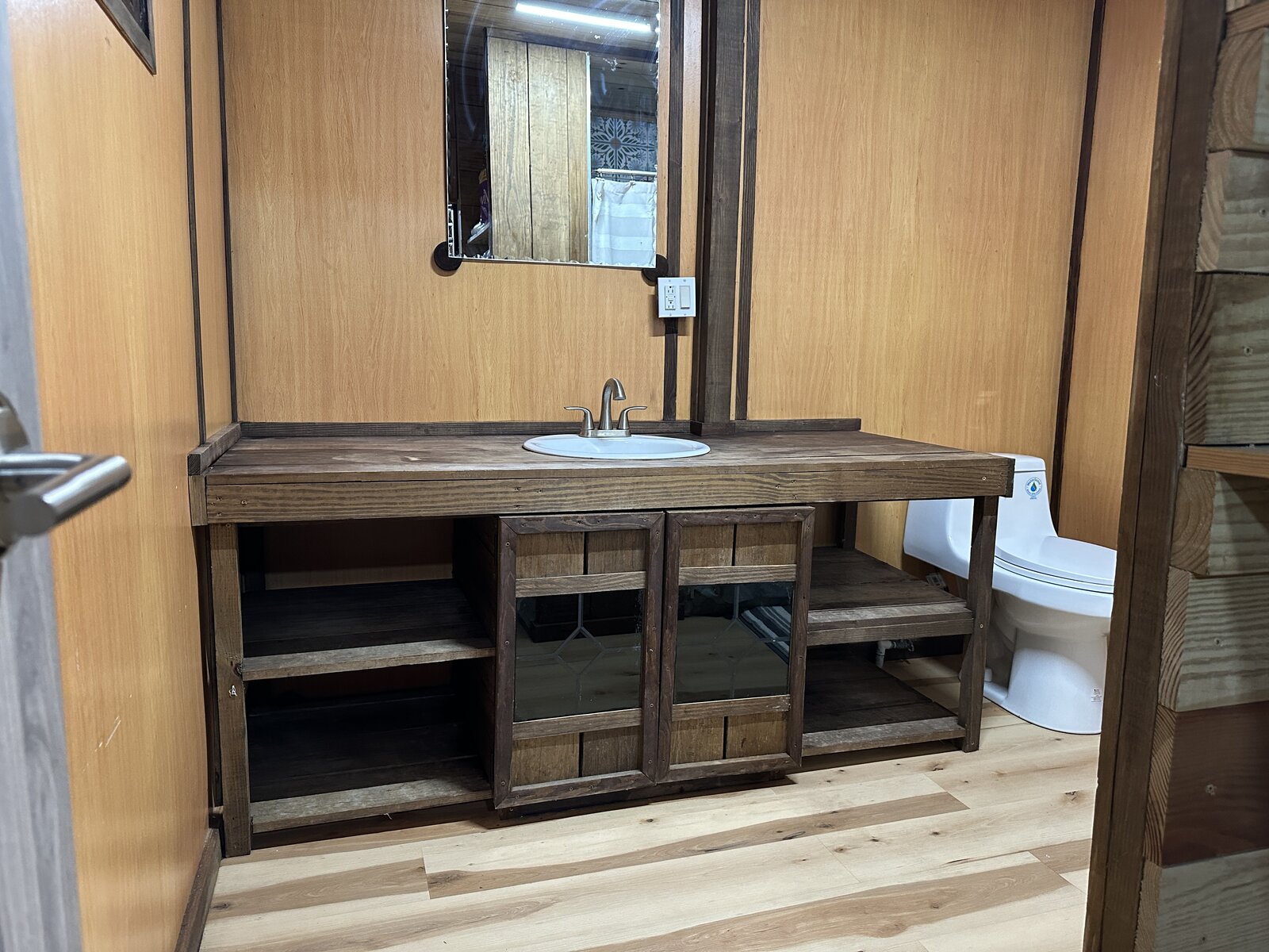 Casa Bambú bathroom with wood vanity, sink, mirror, and toilet